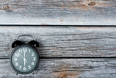 Close-up of old clock on wooden wall