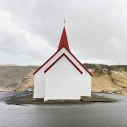 Daytime symmetry. typical small icelandic church. the photo highlights its symmetry and clean lines.