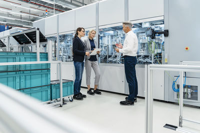 Businessman having discussion with coworkers at electrical industry