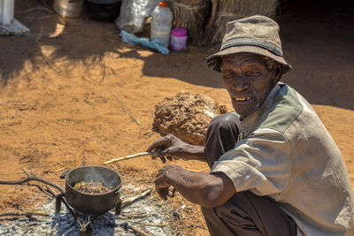 Side view of man wearing hat