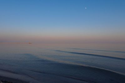Scenic view of sea against sky at sunset