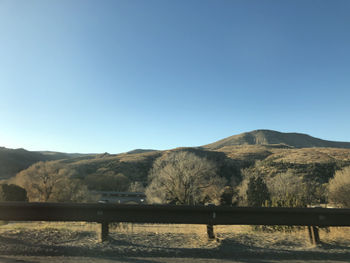 Scenic view of mountains against clear blue sky