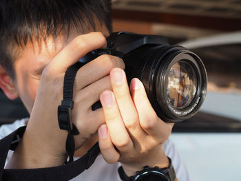 Close-up portrait of boy photographing