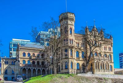 Low angle view of building against clear blue sky