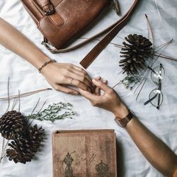 High angle view of couple holding hands on table