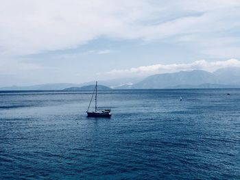 Sailboat sailing on sea against sky