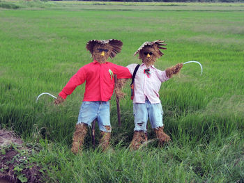 View of scarecrows on agriculture field