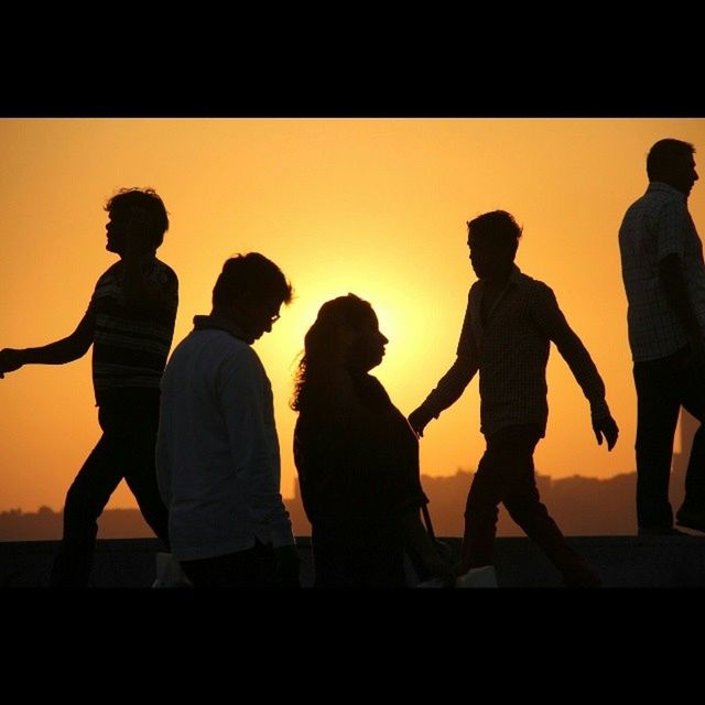 togetherness, sunset, men, silhouette, lifestyles, leisure activity, orange color, bonding, friendship, standing, person, love, boys, full length, medium group of people, family