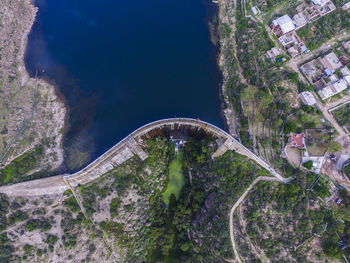 High angle view of road amidst trees against sky