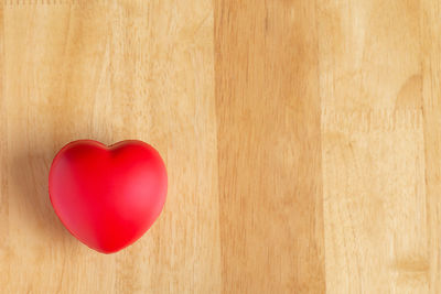 Directly above shot of red heart shape on table