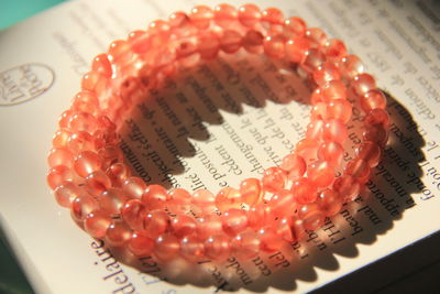 Close-up of beads bracelet on book