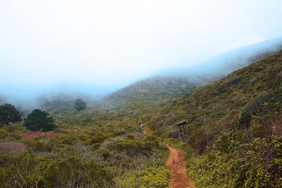 Scenic view of landscape against cloudy sky