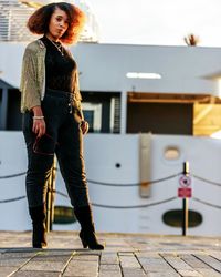 Full length portrait of young woman standing in gym