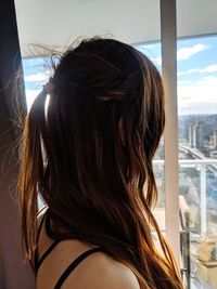 Rear view of woman with hair against sky