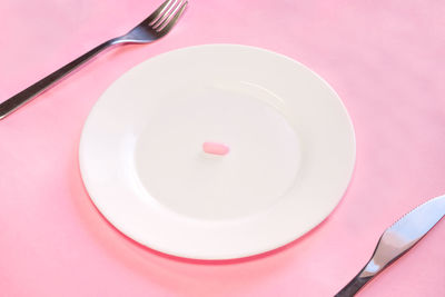 High angle view of spoon with fork on table