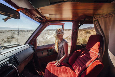 Woman opening door of camper van