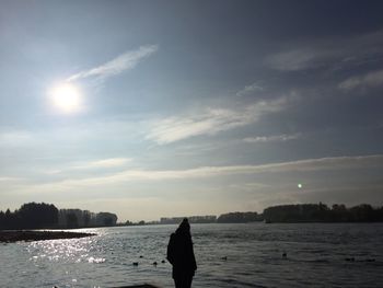 Silhouette man on beach against sky at night