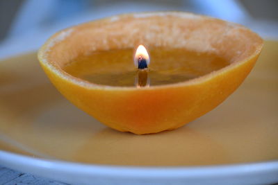 High angle view of lit candle on table