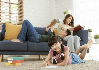 Women sitting on sofa at home