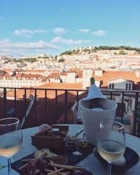 Chairs and tables at dining table against sky in city