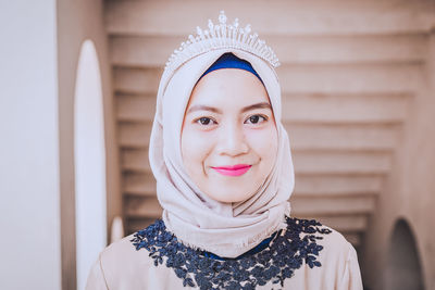 Portrait of smiling young woman headscarf and tiara