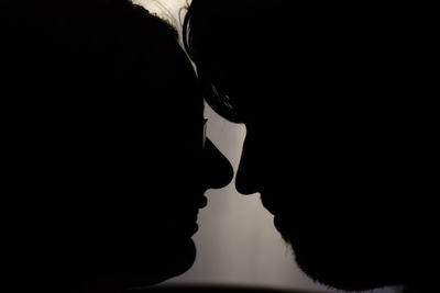 Close-up portrait of silhouette man and woman