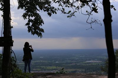 Woman overlooking countryside landscape