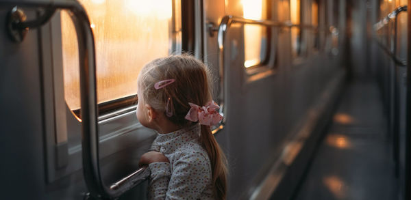 Rear view of woman sitting in train