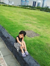 High angle view of woman sitting on grass