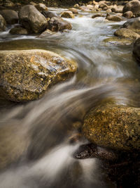 View of stream flowing through rocks