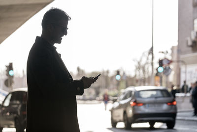 Side view of man standing on street