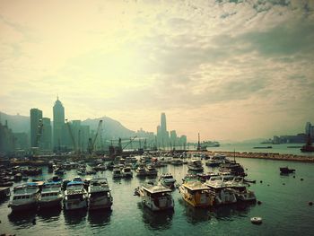 Boats moored at victoria harbour against cloudy sky