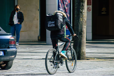 Man riding bicycle on street in city