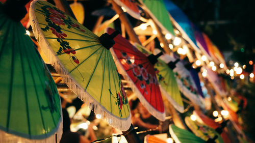 Close-up of multi colored decorations hanging in row