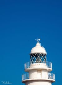 Low angle view of lighthouse against clear blue sky