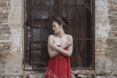 Woman standing against window