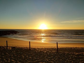 Scenic view of beach against sky during sunset