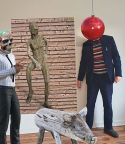 Man standing by statue on table