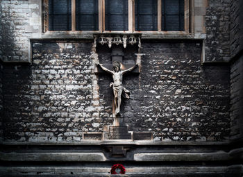 Jesus statue mounted on stone wall