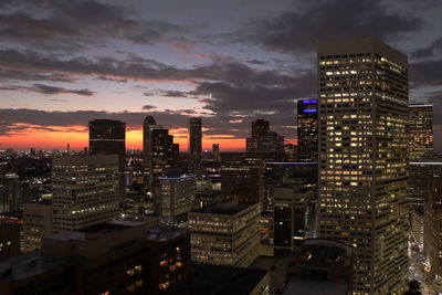 High angle view of illuminated buildings against sky at night