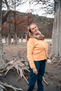 Portrait of a smiling young woman standing on land