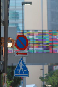 Road sign against pole in city