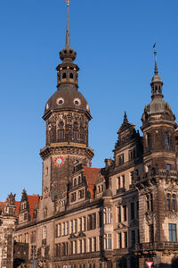 Low angle view of buildings in city against clear sky
