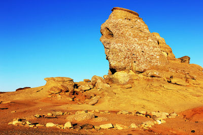 Sphinx rock formation against clear blue sky at bucegi natural park