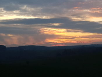 Scenic view of silhouette mountain against sky at sunset
