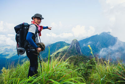 Full length of man standing on mountain against sky