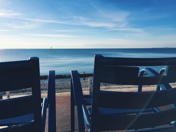 Sunlight, blue chairs, blue sea and blue sky in nice on the french riviera