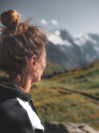 Side view of woman looking at mountains