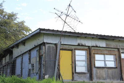 Low angle view of antenna outside house