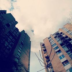 Low angle view of building against cloudy sky